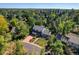 Aerial view of a two-story house with a large backyard, located in a tree-lined neighborhood at 1866 W Davies Ave, Littleton, CO 80120