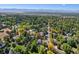 An aerial view of a house with a large backyard, surrounded by lush greenery and other homes at 1866 W Davies Ave, Littleton, CO 80120