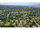 Aerial view of a house with a spacious yard, surrounded by mature trees in a residential area at 1866 W Davies Ave, Littleton, CO 80120