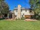 Home's backyard showcasing a patio and expansive lawn at 1866 W Davies Ave, Littleton, CO 80120