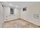 Finished basement room featuring tile floors and large window at 1866 W Davies Ave, Littleton, CO 80120