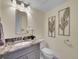 Updated bathroom with granite vanity and decorative wall art at 1866 W Davies Ave, Littleton, CO 80120