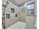 Bathroom with a tiled shower and tub, featuring blue mosaic accents at 1866 W Davies Ave, Littleton, CO 80120