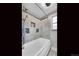 Bathroom with a shower/tub combo and tile surround at 1866 W Davies Ave, Littleton, CO 80120