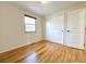 Well-lit bedroom featuring hardwood floors and closet at 1866 W Davies Ave, Littleton, CO 80120