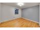 Bright bedroom with gray accent wall, hardwood floors, and a large window at 1866 W Davies Ave, Littleton, CO 80120