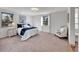 Main bedroom with queen-size bed and sitting area at 1866 W Davies Ave, Littleton, CO 80120