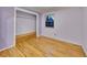 Light purple bedroom with wood floors, built-in bench, and ample closet space at 1866 W Davies Ave, Littleton, CO 80120