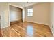 Hardwood floor bedroom with a window and built-in shelving at 1866 W Davies Ave, Littleton, CO 80120