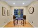 Bright breakfast nook features a glass table and two chairs, with a view of the backyard at 1866 W Davies Ave, Littleton, CO 80120