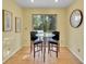 Bright breakfast nook with glass table and two chairs, near sliding door at 1866 W Davies Ave, Littleton, CO 80120