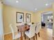 Formal dining room with wood table and six beige chairs at 1866 W Davies Ave, Littleton, CO 80120