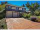 Two-story house with a beige facade, attached two-car garage, and landscaped yard at 1866 W Davies Ave, Littleton, CO 80120