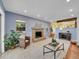 Open living room with fireplace, view into kitchen and dining area at 1866 W Davies Ave, Littleton, CO 80120