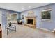 Living room with fireplace, and sliding glass doors to backyard at 1866 W Davies Ave, Littleton, CO 80120