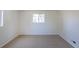 Bright carpeted bedroom with a large window for natural light at 3570 Center Ave, Denver, CO 80219