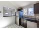 The kitchen features stainless steel appliances, tile countertops, and dark wooden cabinets at 3570 Center Ave, Denver, CO 80219
