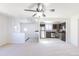 Bright, open living room and kitchen with neutral carpet and ceiling fan at 3570 Center Ave, Denver, CO 80219
