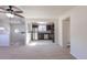 Bright, open living room and kitchen with neutral carpet and ceiling fan at 3570 Center Ave, Denver, CO 80219