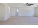 Large carpeted living room with open doorway and ceiling fan at 3570 Center Ave, Denver, CO 80219
