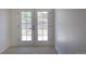 Bright room featuring double doors leading to the backyard, offering natural light at 3570 Center Ave, Denver, CO 80219