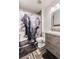 Stylish bathroom featuring updated fixtures, a vanity, and a themed shower curtain at 10129 Glencoe Ct, Thornton, CO 80229