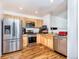 Modern kitchen with stainless steel appliances, granite countertops, and wood cabinets at 10129 Glencoe Ct, Thornton, CO 80229