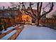 Backyard view featuring wooden fence, steps to a charming back porch, and an established shade tree at 1586 Steele St, Denver, CO 80206