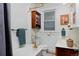 Charming bathroom showcases a vintage clawfoot tub with brass fixtures and a wood vanity at 1586 Steele St, Denver, CO 80206