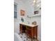 Bathroom features a wood vanity with a marble countertop and a vintage mirror at 1586 Steele St, Denver, CO 80206