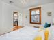 Bedroom featuring white walls, stained glass windows and a connected office space at 1586 Steele St, Denver, CO 80206