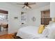 Bedroom features a bed with white bedding, two windows, and an adjacent room with a desk and chair at 1586 Steele St, Denver, CO 80206