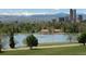 Scenic view of Denver skyline and mountains across the lake and park at 1586 Steele St, Denver, CO 80206