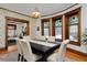 Inviting dining room featuring hardwood floors, stained glass windows and an adjacent living room at 1586 Steele St, Denver, CO 80206