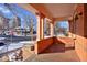 Inviting front porch featuring decorative columns, brick accents, and a cozy outdoor space at 1586 Steele St, Denver, CO 80206