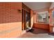 Close-up of a charming front porch with brick details, decorative columns, and a welcoming entrance at 1586 Steele St, Denver, CO 80206