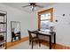 Home office with stained glass window, ceiling fan and a traditional wood desk at 1586 Steele St, Denver, CO 80206