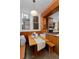 Eat-in kitchen nook featuring built-in bench, wood paneling and light-filled windows at 1586 Steele St, Denver, CO 80206