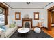 Bright living room features decorative fireplace, hardwood floors and a neutral color palette at 1586 Steele St, Denver, CO 80206