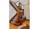 Detailed staircase features carpeted steps, dark wood banister and built in seating at 1586 Steele St, Denver, CO 80206