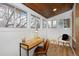 Bright sunroom with wood-paneled ceiling features several windows, a desk, and chair, providing ample natural light at 1586 Steele St, Denver, CO 80206