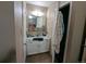 Bathroom features white cabinets and sink vanity, and a decorative mirror at 155 Paris Cir, Aurora, CO 80011