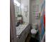 Bathroom features a vanity sink, an artistic sign on the wall, and functional decor at 155 Paris Cir, Aurora, CO 80011