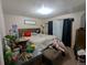 Cozy bedroom featuring wood headboard, neutral walls, and curtains for a warm ambiance at 155 Paris Cir, Aurora, CO 80011