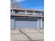 Attached garage showing the garage door and house number at 155 Paris Cir, Aurora, CO 80011