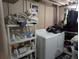Functional laundry area with washer, dryer, and storage shelves for organization at 155 Paris Cir, Aurora, CO 80011