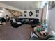 Spacious living room featuring a comfortable sectional sofa and stairs leading to upper level at 155 Paris Cir, Aurora, CO 80011