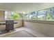 View of the balcony with a gas grill and outdoor carpet, overlooking the trees at 6731 S Kearney Ct, Centennial, CO 80112