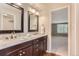 Bathroom features double sinks, granite countertops, and dark wood cabinetry at 6731 S Kearney Ct, Centennial, CO 80112