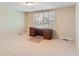 Bedroom with neutral carpet, plantation shutters, and a dark wood desk at 6731 S Kearney Ct, Centennial, CO 80112